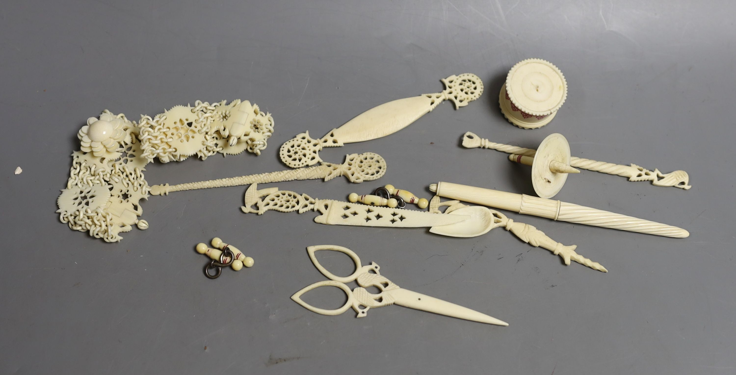 A group of 19th century/early 20th century carved ivory chains, sewing accessories, bracelets etc.
